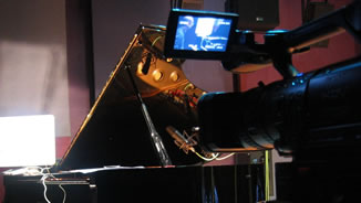 Video camera set up to film the piano player during performance